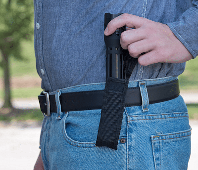 stun gun drawn from holster placed in belt