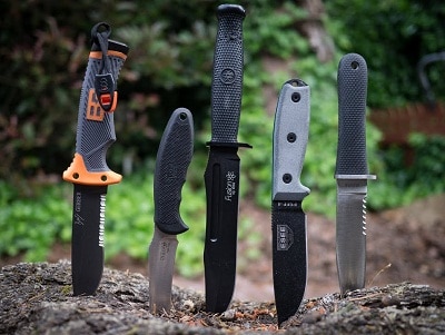 Survival knives poked on the ground