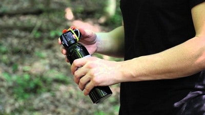 man holding bear spray with both hands