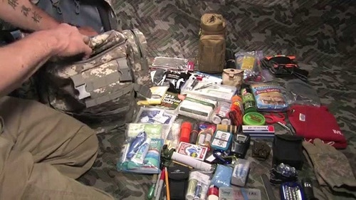 man packing a bug out bag