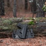 Pistol resting on fallen tree trunk