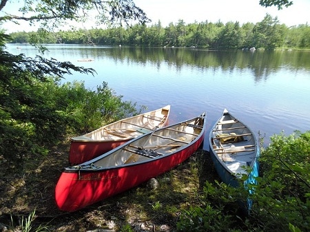 3 canoes parked by the lake