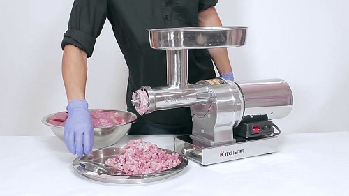electric meat grinder with raw meat on the side