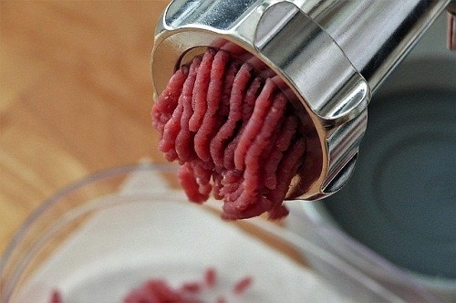 ground meat coming out of grinder