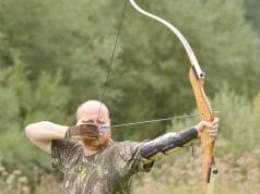 man hunting with recurve bow