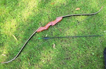 recurve bow and arrow on the grass