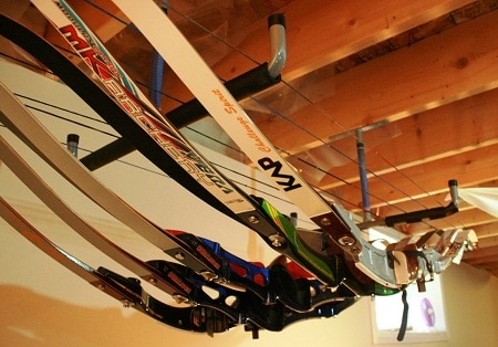 recurve bows hanging on rack