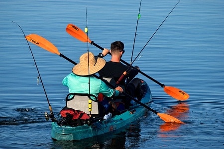 back view of fishers paddling kayak