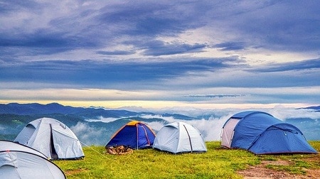 different tents on mountain peak