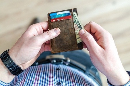 Hand pulling out money from wallet