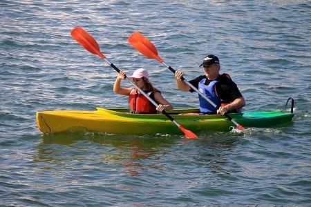 man and woman paddling kayak