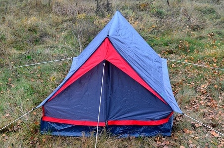 pegged enclosed tent on dry grass land