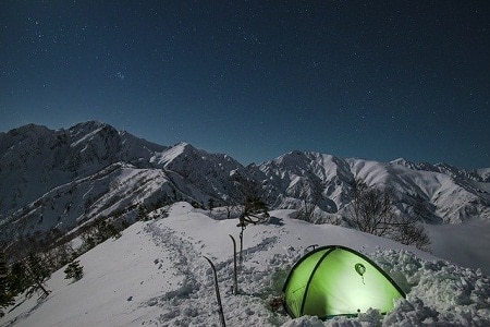 tent pitched on a snow covered peak