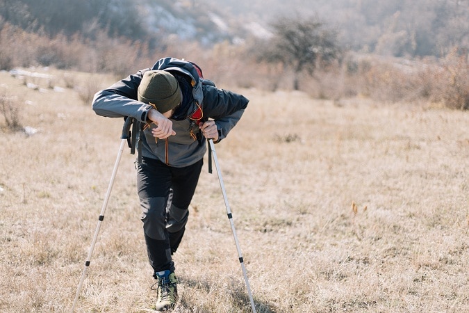 tired hiker uphill front view