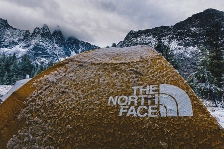 wet Northface tent in a snow covered landscape