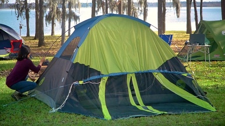 woman setting up a tent