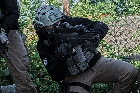 fully geared air softer kneeling for a shot