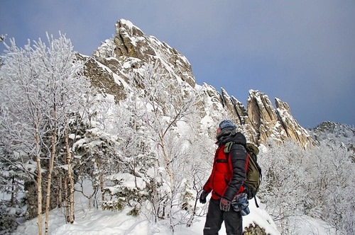 hiker looking at the snowy mountain peak