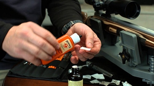 man deep cleaning rifle with Hoppe's