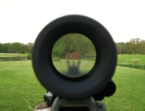 view through a magnifier rifle aiming with holographic sight