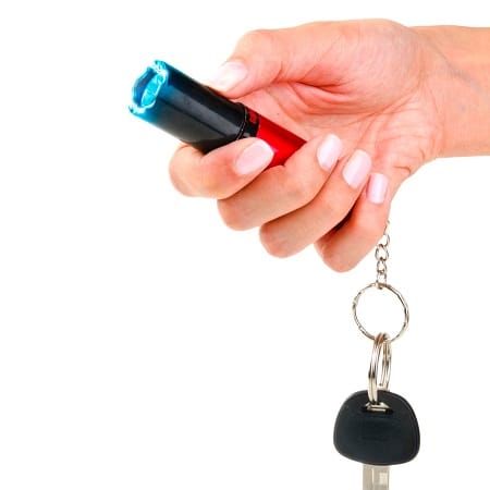 woman hand holding stun gun keychain