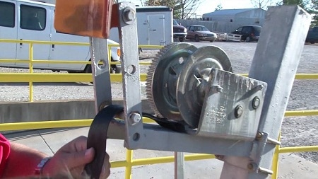 hand holding strap of boat winch