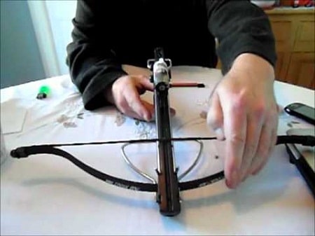 hand measuring pistol crossbow on table