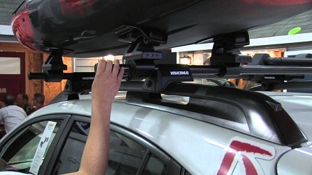hand on a Yakima roof rack installed in a car
