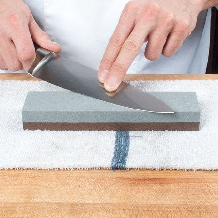 hand sharpening knife on a Whetstone