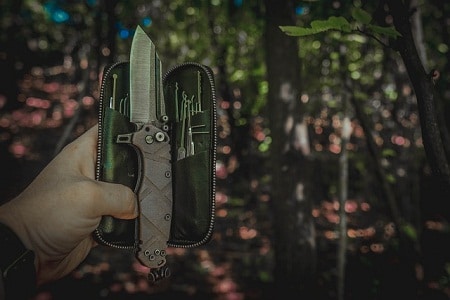 knife set held out in the woods