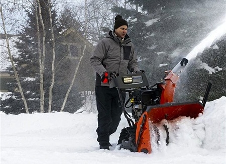 man clearing snow with HUSQVARNA 30-inch Model ST330T