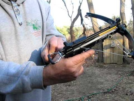 man holding pistol crossbow