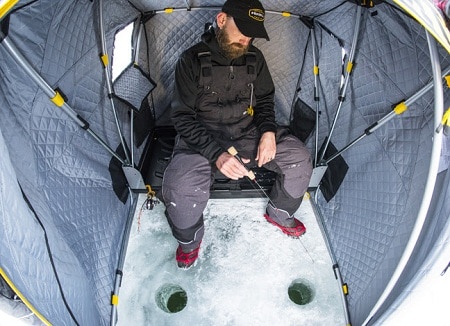 man ice fishing in Frabill Recruit ice tent