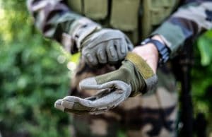 man in uniform wearing tactical gloves