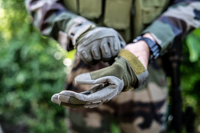 man in uniform wearing tactical gloves