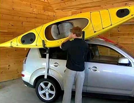 man loading kayak on car roof with load assist feature