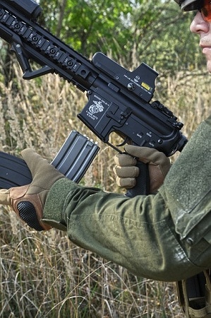 man reloading airsoft rifle magazine