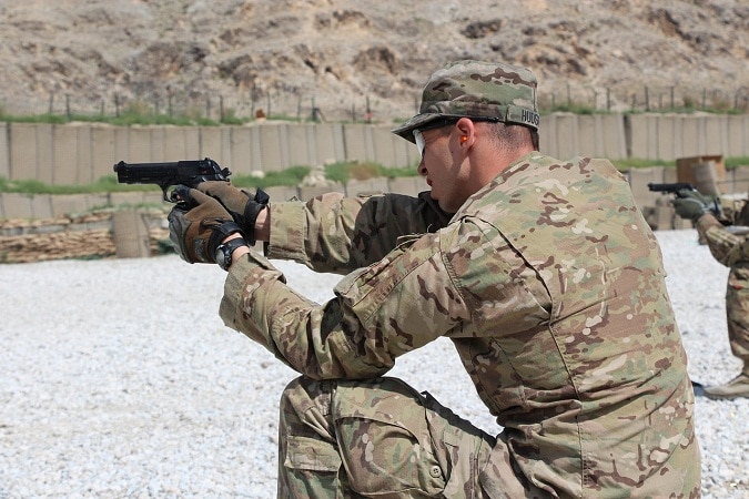 military practice shooting pistol on range