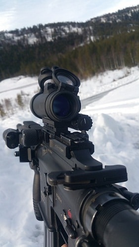 optic on rifle in snow covered field