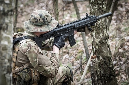 soldier aiming rifle in the forest