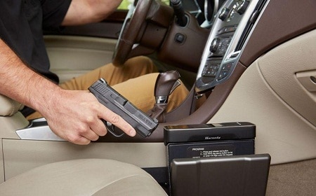 driver holding pistol from a Hornady Rapid Safe