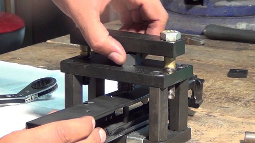 hands working on Trunnion riveting jig