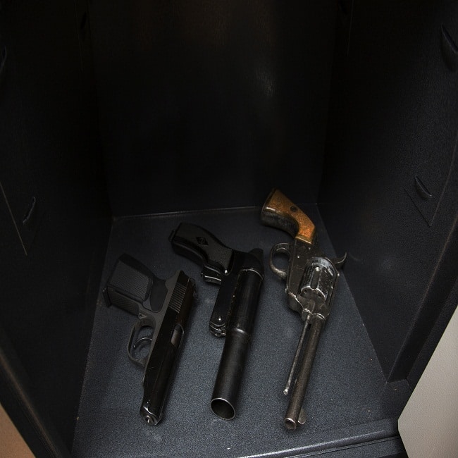three pistols in the open safe