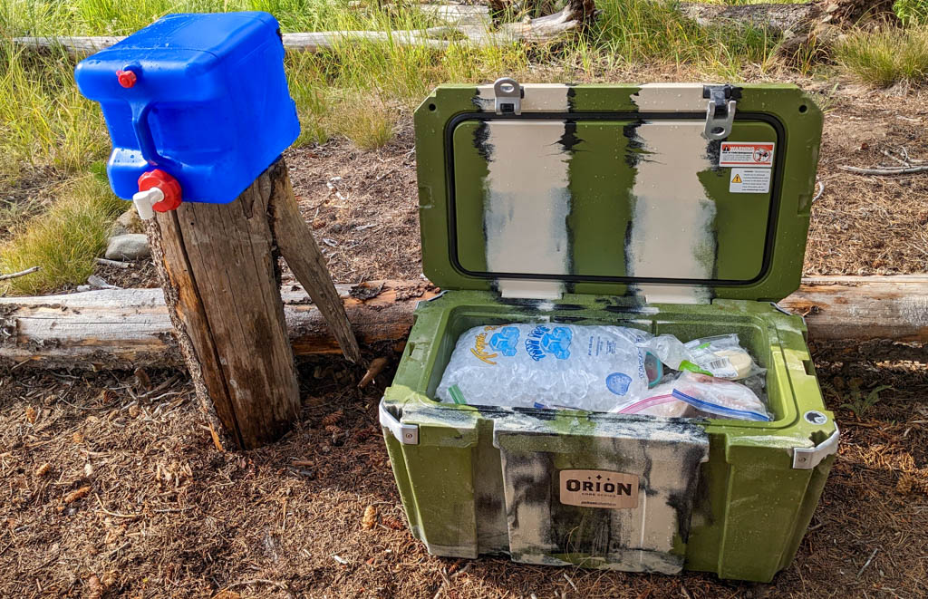 Orion core 65 cooler on ground while camping