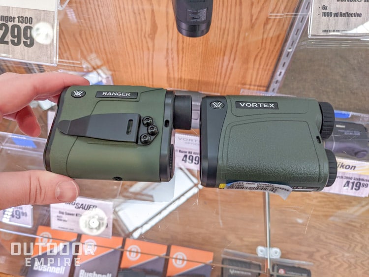 Two rangefinders sitting on glass case