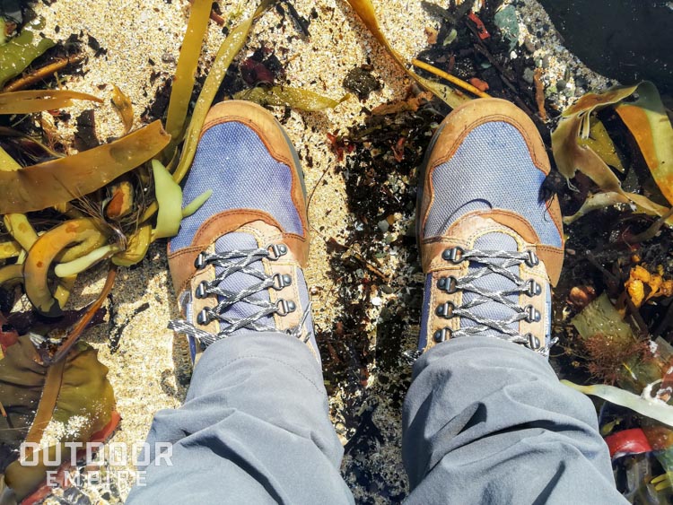 Looking down at feet standing in water in Kodiak Skogan boots