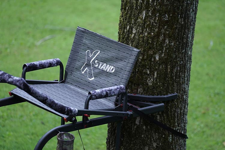 Tree stand seat attached to a tree