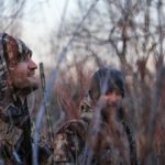 Hunters camouflaged in the woods