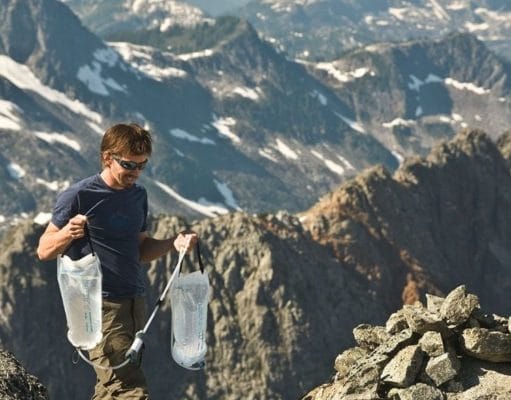 hiker carrying Platypus water reservoir on rocky mountain