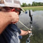 Man aiming arrow to bowfish